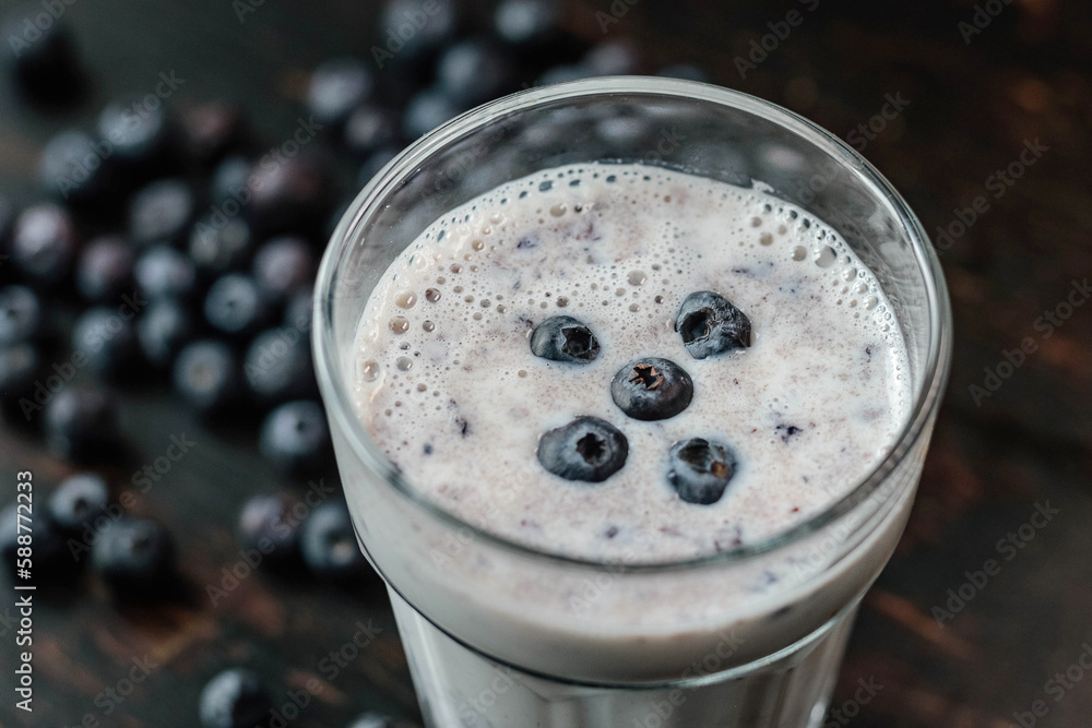 blueberry smoothie and fresh berry on the dark background. Concept healthy eating blueberry smoothie and fresh berry on the dark background. Concept healthy eating
