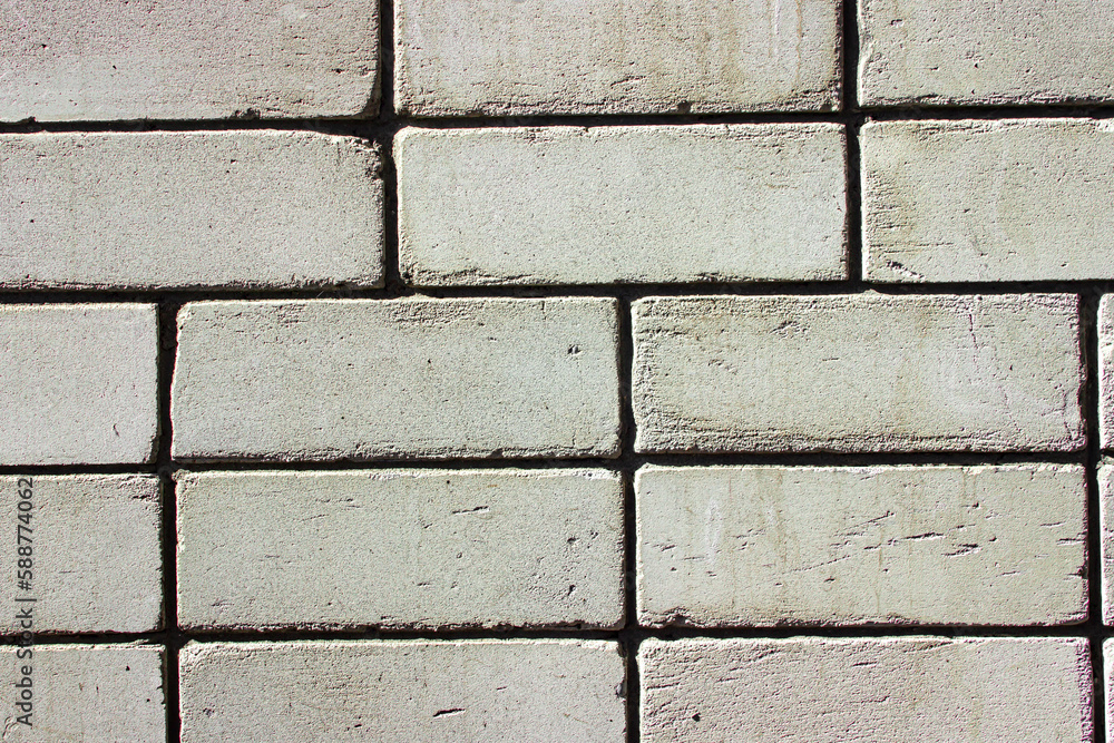Obraz premium White brick wall as a background for the image.