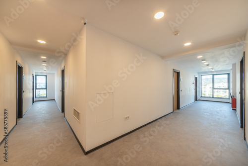 Interior of a hotel corridor doorway. Narrow hallway with closed doors. Campus