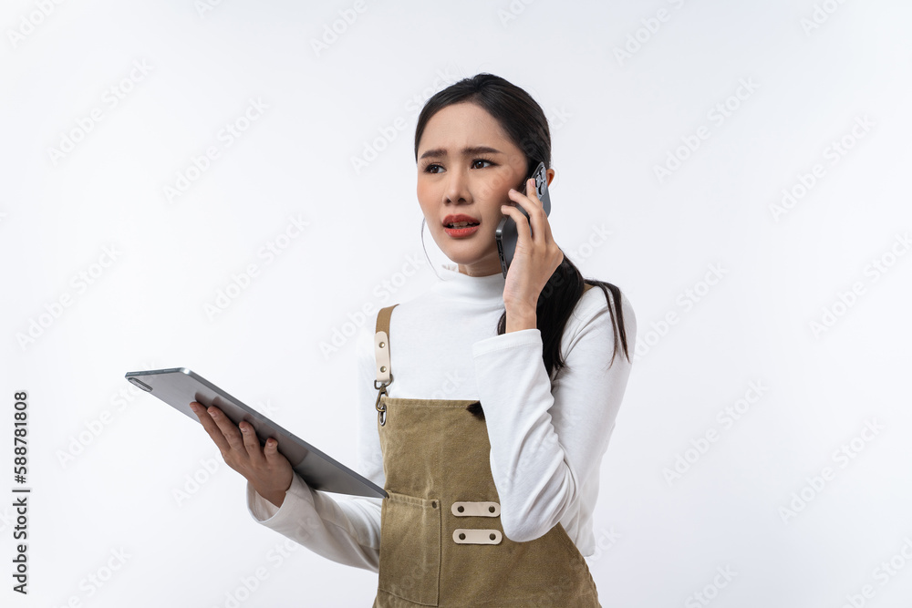Young Asian woman using tablet and speaking on smartphone isolated on white background. Young Asian woman using tablet and speaking on smartphone isolated on white background.
