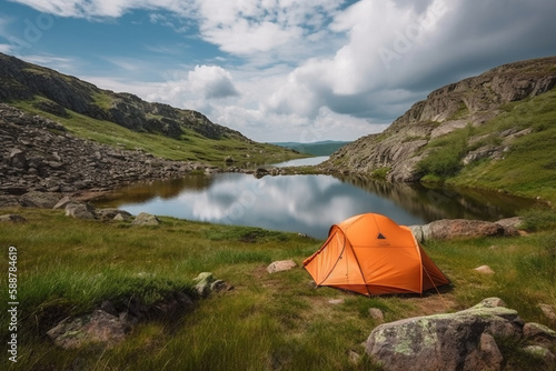 Orange tent next to a serene lake in a beautiful mountain landscape, representing the peace and tranquility of camping in nature.Ai generated © twindesigner