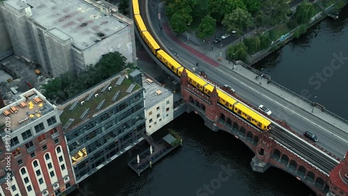 Aerial approach toward Oberbaum bridge with rapid transit train crossing, Berlin photo