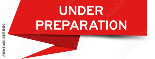 Red color speech banner with word under preparation on white background