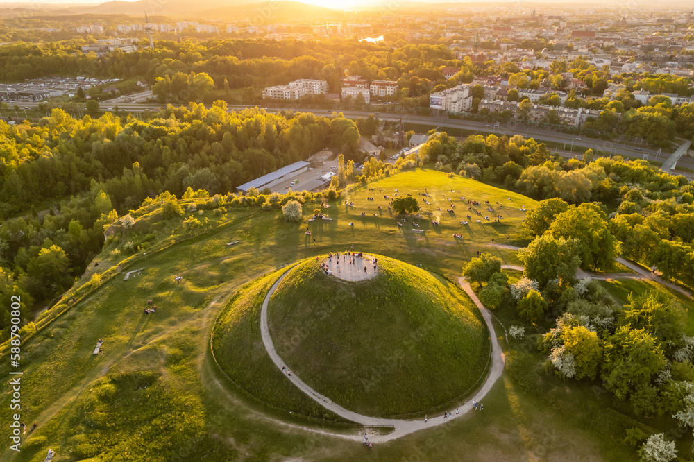 Aerial view of the Krakus Mound with sunset view of the historical part of Krakow old town, Poland. - obrazy, fototapety, plakaty 