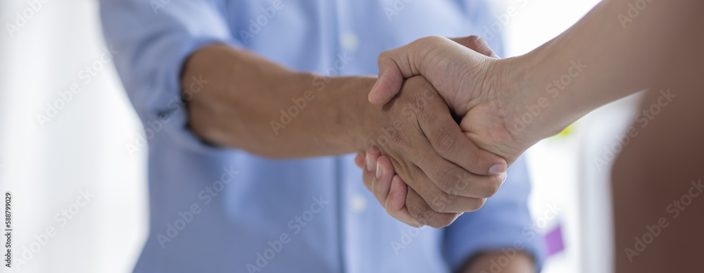 Fototapeta premium Businessman handshake for teamwork of business merger and acquisition,successful negotiate,hand shake,two businessman shake hand with partner to celebration partnership and business deal concept