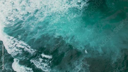 Huge waves crash on the reef. Beautiful texture of water and foam. Aerial view photo