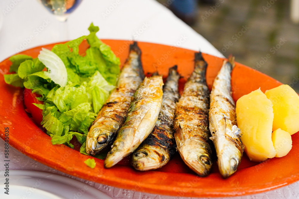 Grilled Portuguese sardines, Traditional Portuguese dishe served on the terrace of a Lisbon restaurant Grilled Portuguese sardines, Traditional Portuguese dishe served on the terrace of a Lisbon restaurant