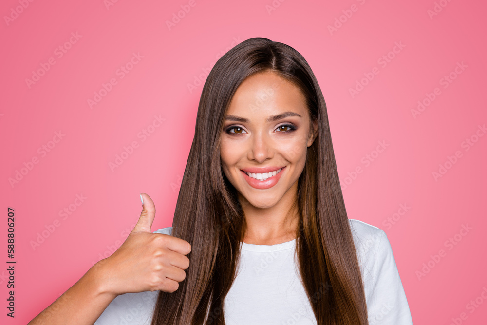 Portrait of brown-haired gorgeous attractive nice smiling young lady over grey background, showing thumbs up gesture, isolated Portrait of brown-haired gorgeous attractive nice smiling young lady over grey background, showing thumbs up gesture, isolated