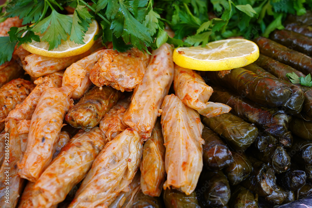 Delicious lahana ve yaprak dolma (sarma) stuffed grape leaves rice, Lebanese dolma sarma on plate. Lebanon turkish greek middle eastern cuisine. Delicious lahana ve yaprak dolma (sarma) stuffed grape leaves rice, Lebanese dolma sarma on plate. Lebanon turkish greek middle eastern cuisine.