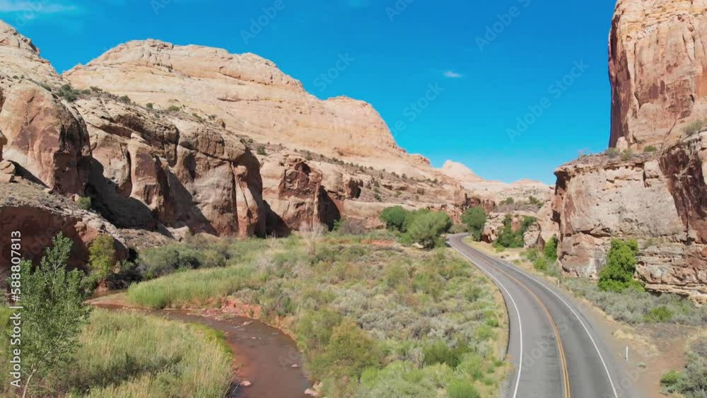 Amazing aerial view of a beautiful road across the canyon mountains and river, summer season Amazing aerial view of a beautiful road across the canyon mountains and river, summer season
