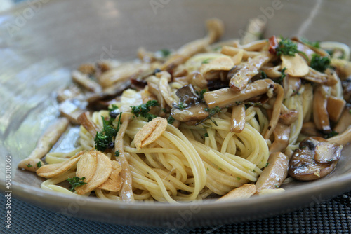 Spaghetti mushroom sauce in gray ceramic bowl