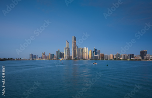 Blue hour cityscape with the skyline of Abu Dhabi. Travel to United Arab Emirates  view to modern skyscraper office buildings.