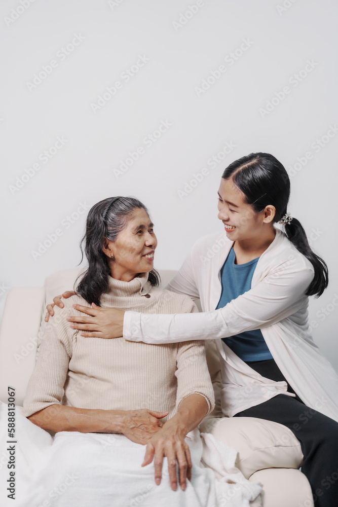 Hugging, love, valentine, care, Elderly mother with young daughter asia people only woman sitting on sofa at home have fun enjoying weekend together.
