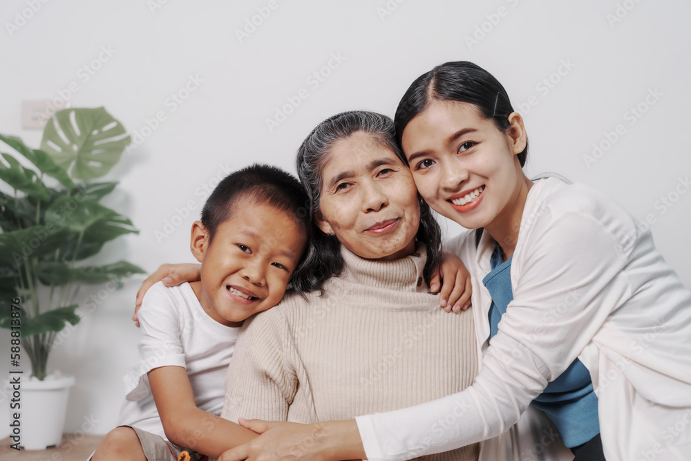 My grandmother and daughter and grandson hugged lovingly while sitting on the sofa with care and warmth, love, valentine, family, care. My grandmother and daughter and grandson hugged lovingly while sitting on the sofa with care and warmth, love, valentine, family, care.