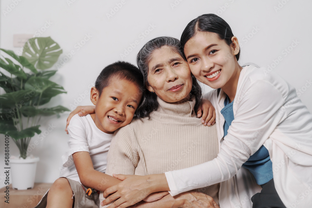 My grandmother and daughter and grandson hugged lovingly while sitting on the sofa with care and warmth, love, valentine, family, care. My grandmother and daughter and grandson hugged lovingly while sitting on the sofa with care and warmth, love, valentine, family, care.