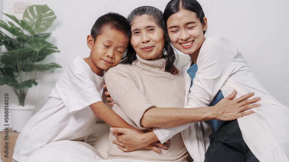 My grandmother and daughter and grandson hugged lovingly while sitting on the sofa with care and warmth, love, valentine, family, care. My grandmother and daughter and grandson hugged lovingly while sitting on the sofa with care and warmth, love, valentine, family, care.