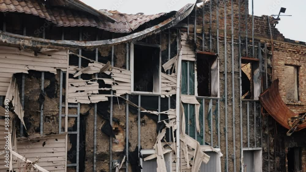 concrete building, damaged by shelling, destroyed city. Sad scene ...