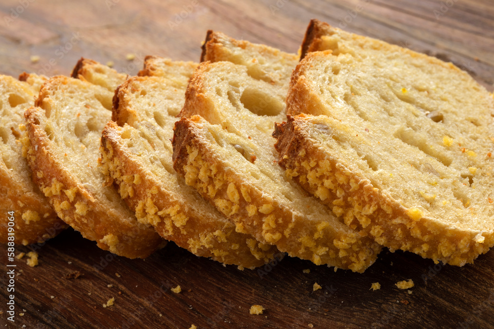 Slices of homemade fresh baked corn bread on a cutting board close up Slices of homemade fresh baked corn bread on a cutting board close up