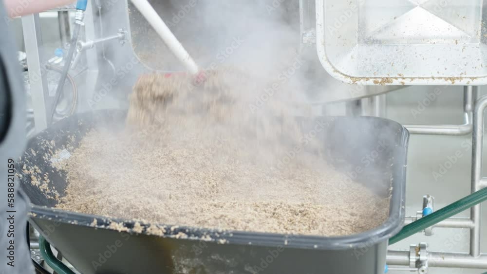 cleaning the boiler from residual malt after brewing beer in the