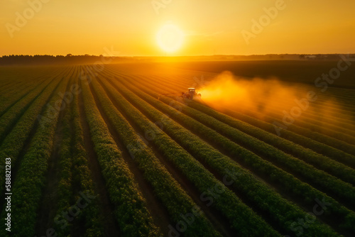 View of Tractor Spraying Pesticides on Soybean Fields.  Generative AI © EwaStudio