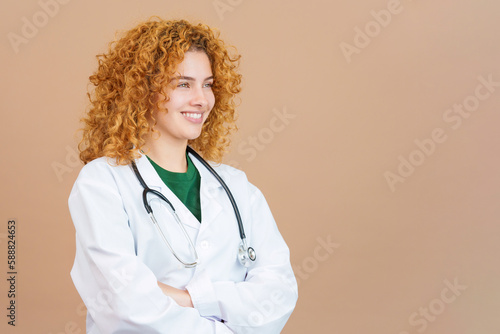 Female doctor looking aside with the arms crossed