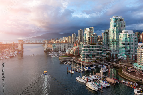 Aerial View of Granville Island in False Creek with modern city skyline and mountains in background. Downtown Vancouver, British Columbia, Canada. Sunset Sky © edb3_16