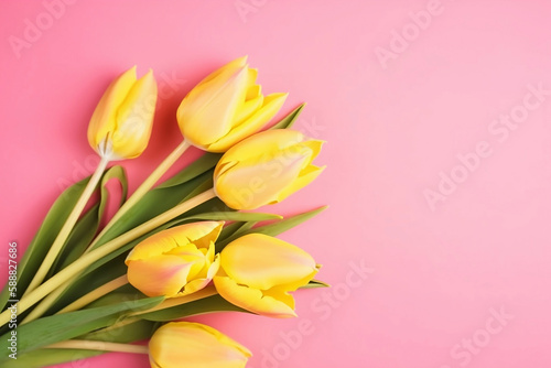bouquet of yellow tulips on yellow background top view