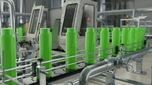 Plastic bottle mass production at the industrial manufacturing facility. Mass production of green plastic bottles for hair care items. Plastic bottle mass production on the factory conveyor belt.