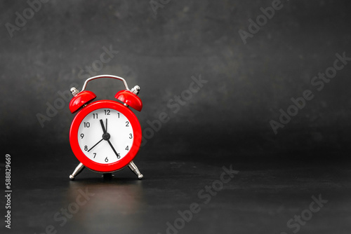 Wallpaper Mural Red bell alarm clock on a dark black background with natural light. Mention of personal care schedule, reminder of medicines and physical exercise for rheumatism, arthrosis and labyrinthitis. Torontodigital.ca