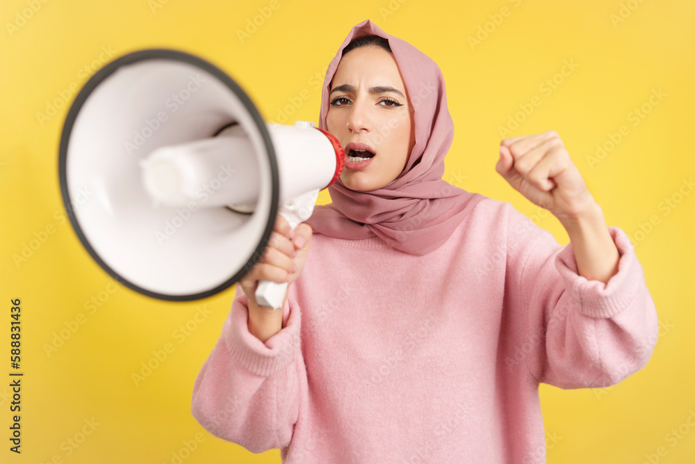 Angry muslim woman screaming using a loudspeaker Angry muslim woman screaming using a loudspeaker