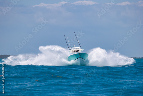 Approaching center console fishing boat making huge spray.