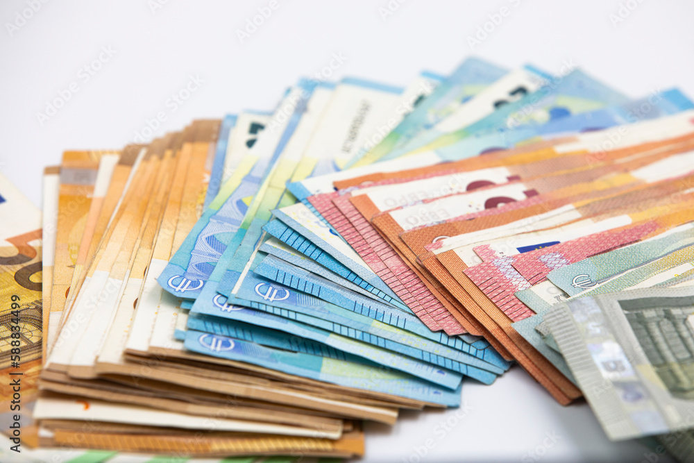 Pile of euro banknotes of 100, 50, 20, 10 and 5 euros. White background