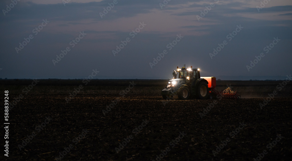 Fototapeta premium Tractor preparing land with seedbed cultivator
