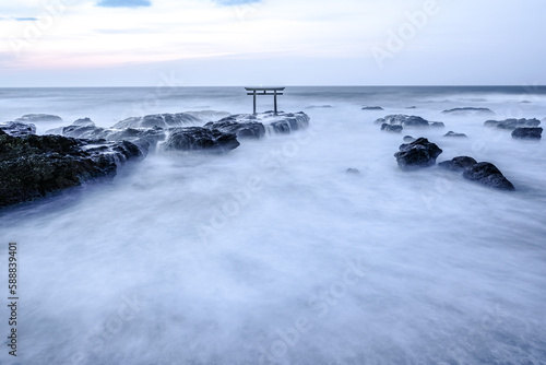a floating tori gate at sunset, japanese, ocean waves breaking at sunset over a wooden tori gate, 