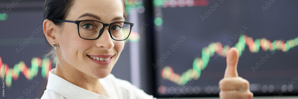 Happy woman trader showing thumb up gesture Happy woman trader showing thumb up gesture