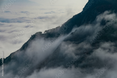 Dramatic Mist and Clouds on Mountain Cliff
