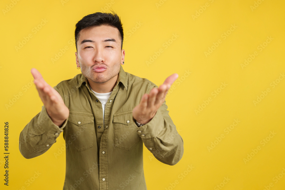 Chinese man blowing a kiss while looking at the camera Chinese man blowing a kiss while looking at the camera