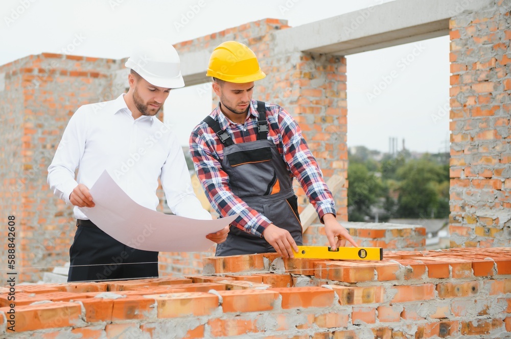 Builder and engineer on construction site Builder and engineer on construction site