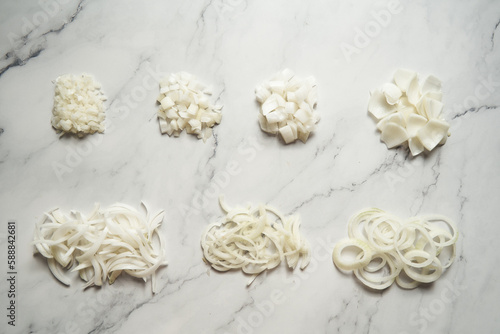 Different cuts of onions. Photo show different onion cuts from small to large dice, rings, chunks and half moon slice plus julienne