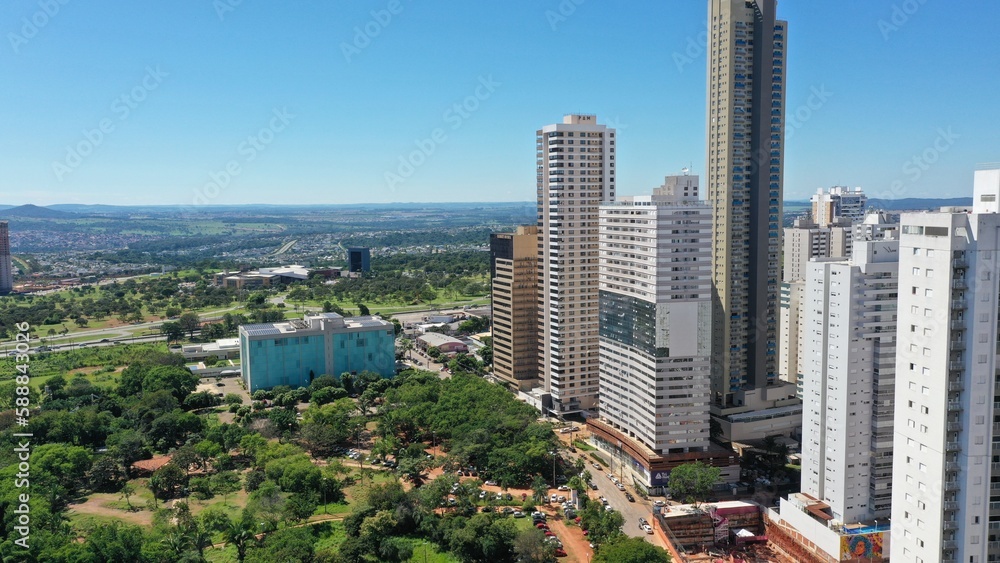 Fototapeta premium Wonderful panoramic view of Flamboyant Park with lakes and tropical trees surrounded by modern residential apartments in Goiania, Goias, Brazil in April, 2023. 