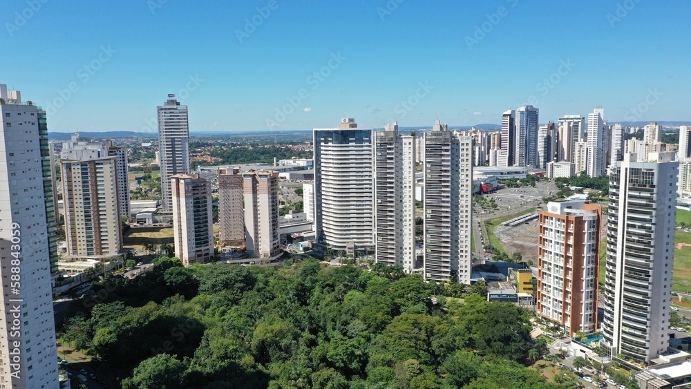 Wonderful panoramic view of Flamboyant Park with lakes and tropical trees surrounded by modern residential apartments in Goiania, Goias, Brazil in April, 2023. 