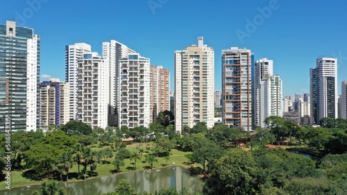 Wonderful panoramic view of Flamboyant Park with lakes and tropical trees surrounded by modern residential apartments in Goiania, Goias, Brazil in April, 2023.  © MARCIA COBAR