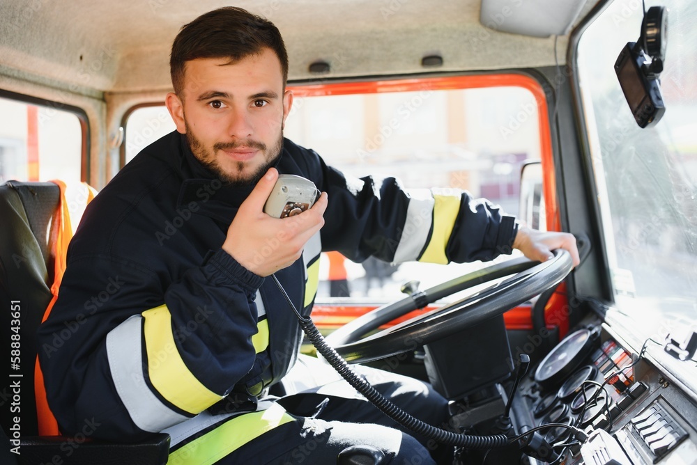 Firefighter using portable radio set in fire truck, space for text Firefighter using portable radio set in fire truck, space for text