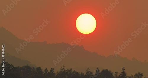 sunset time lapse. Big bright Yellow sun moves down.Day to night transition.