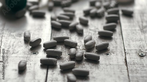 Close-up shot of pile of pills on table - mosern drug and pharmacy addiction, pharmaceutical industry concept 4k footage photo