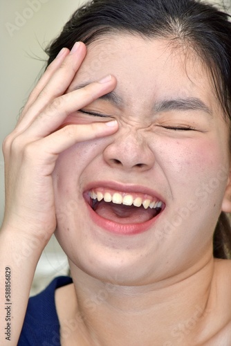A Youthful Chinese Female Laughing