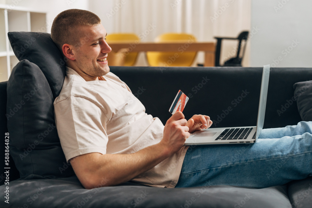 A happy Caucasian man is shopping online A happy Caucasian man is shopping online