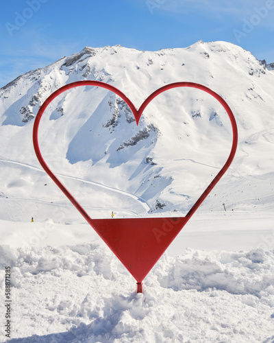 Obraz na płótnie Photo frame shaped like a red heart in Val d'Isere ski resort, France, in Winter, used for tourists to take photos with the slopes and mountains in the background. w salonie