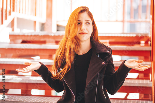 Young woman making decision or choice and showing pose - I don't know