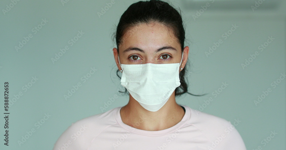 Girl putting on face mask prevention against Covid 19 pandemic. Woman wearing mask against corona virus infection Girl putting on face mask prevention against Covid 19 pandemic. Woman wearing mask against corona virus infection